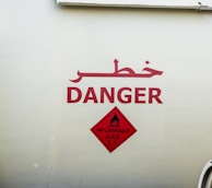 Warning signs and instructions posted near LPG cylinder storage.