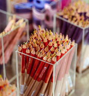 Rows of neatly organized pencils and pens in a bright, modern workspace.