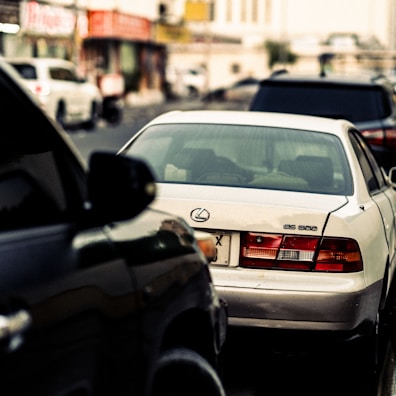 The Lexus ES showcased on a modern urban street with soft reflections highlighting its curves.