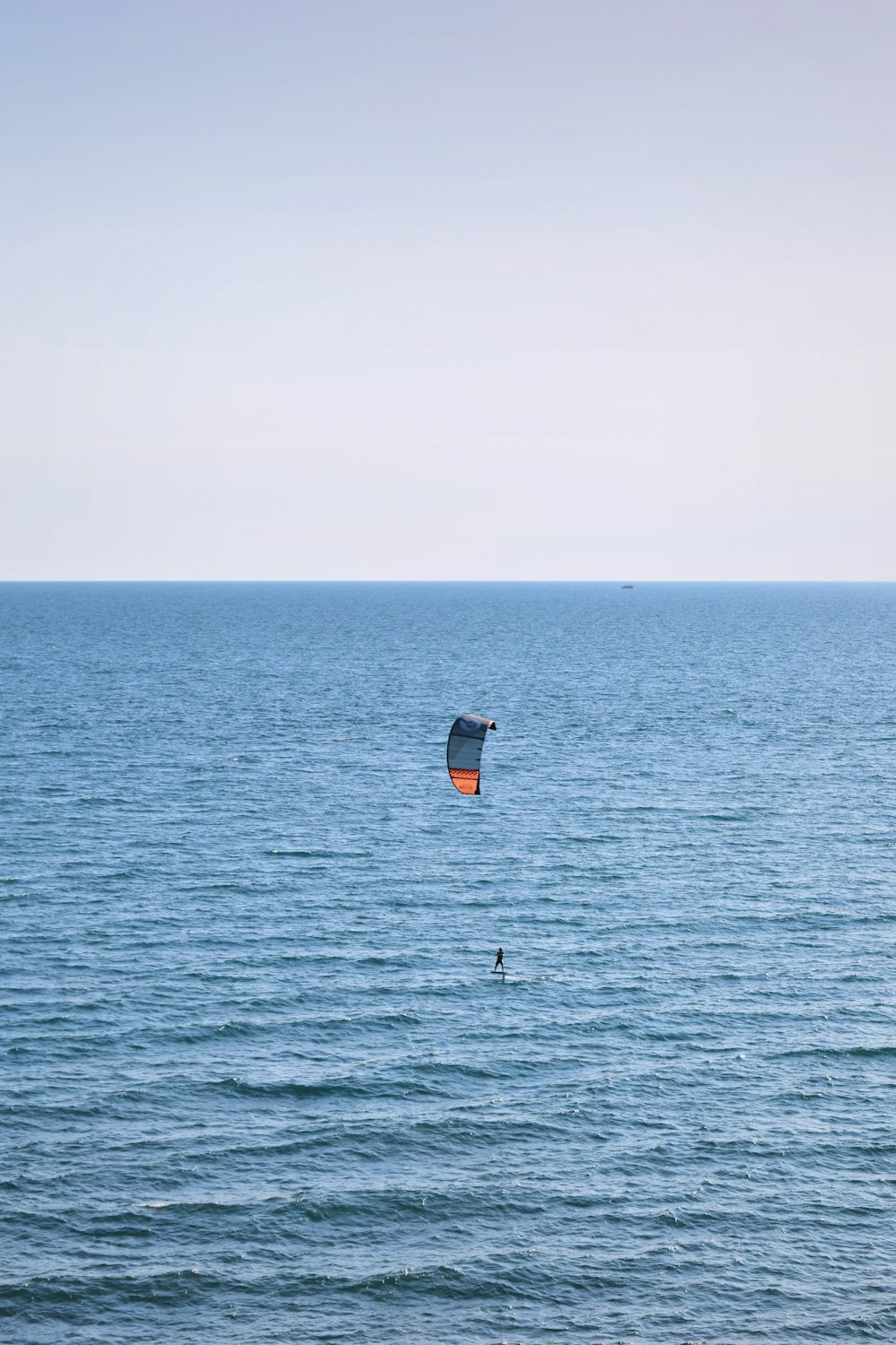 a parasailer in the middle of a large body of water