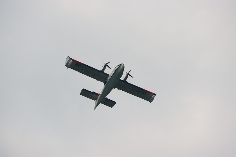 a small airplane flying through a cloudy sky