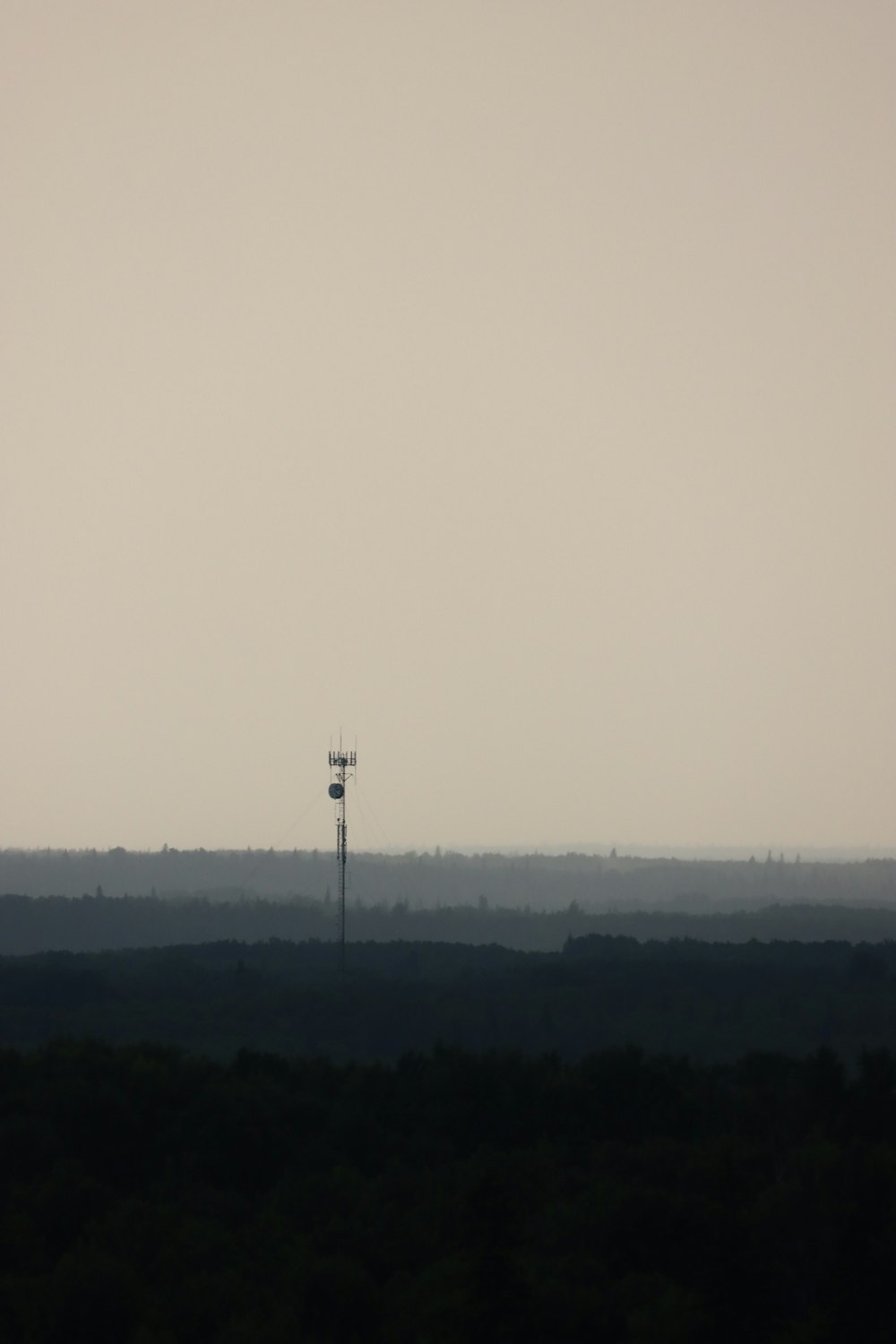 a large field with a tower in the distance