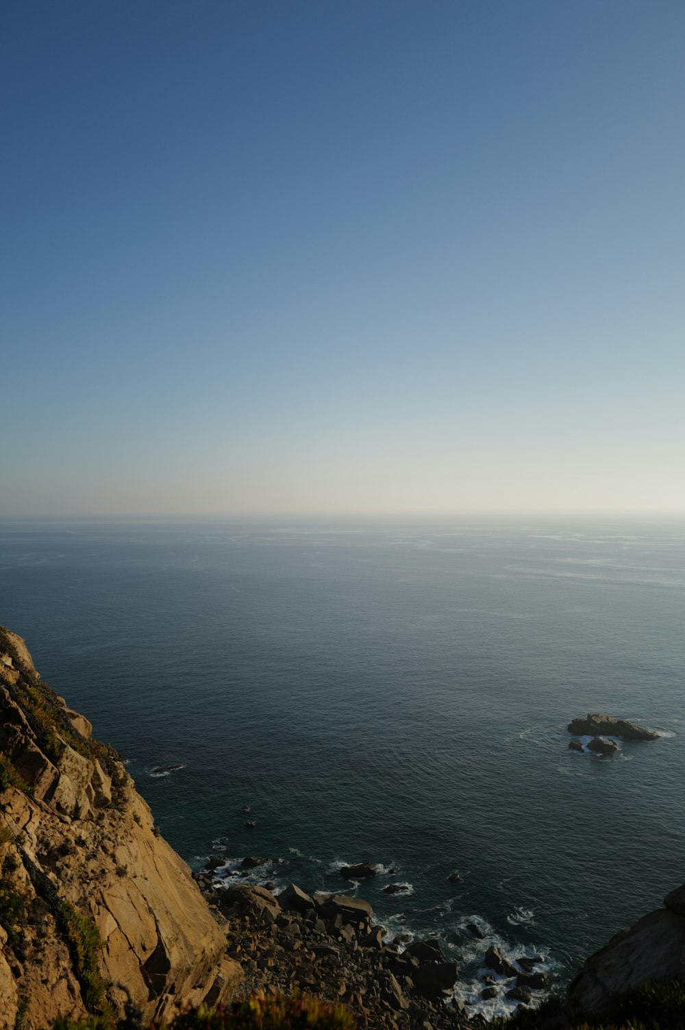 a view of the ocean from the top of a hill