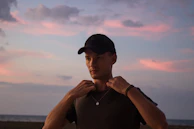 Evening scene showing a woman adjusting her waterproof jewelry before heading out.