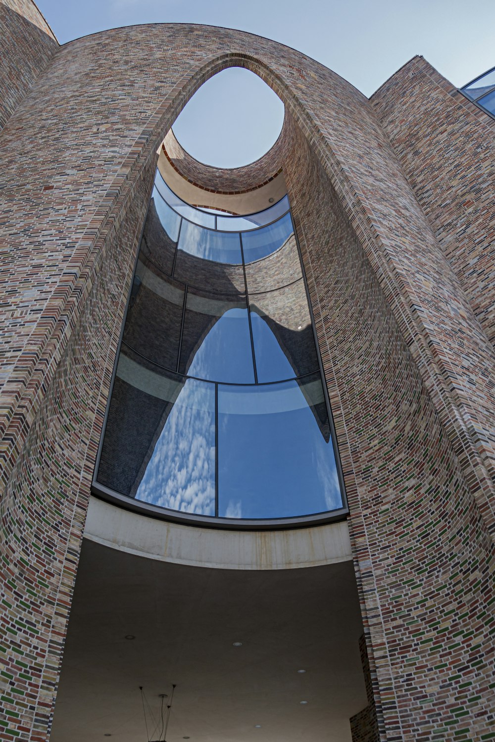 a very tall brick building with a circular window