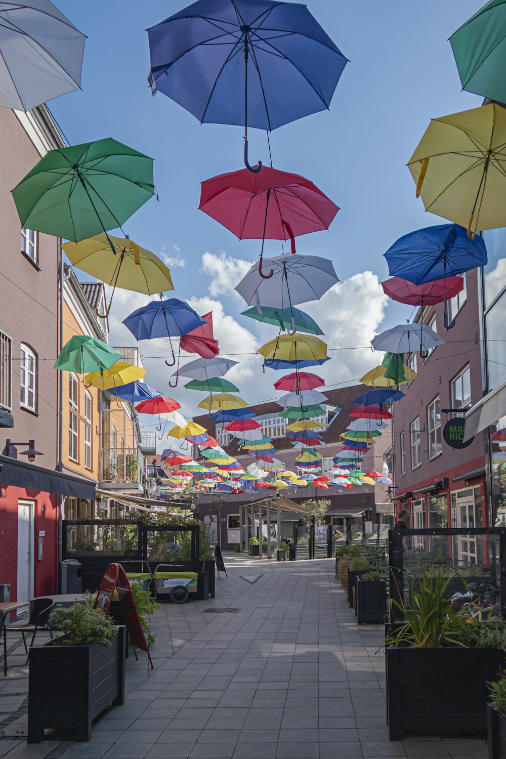 a bunch of umbrellas that are hanging in the air