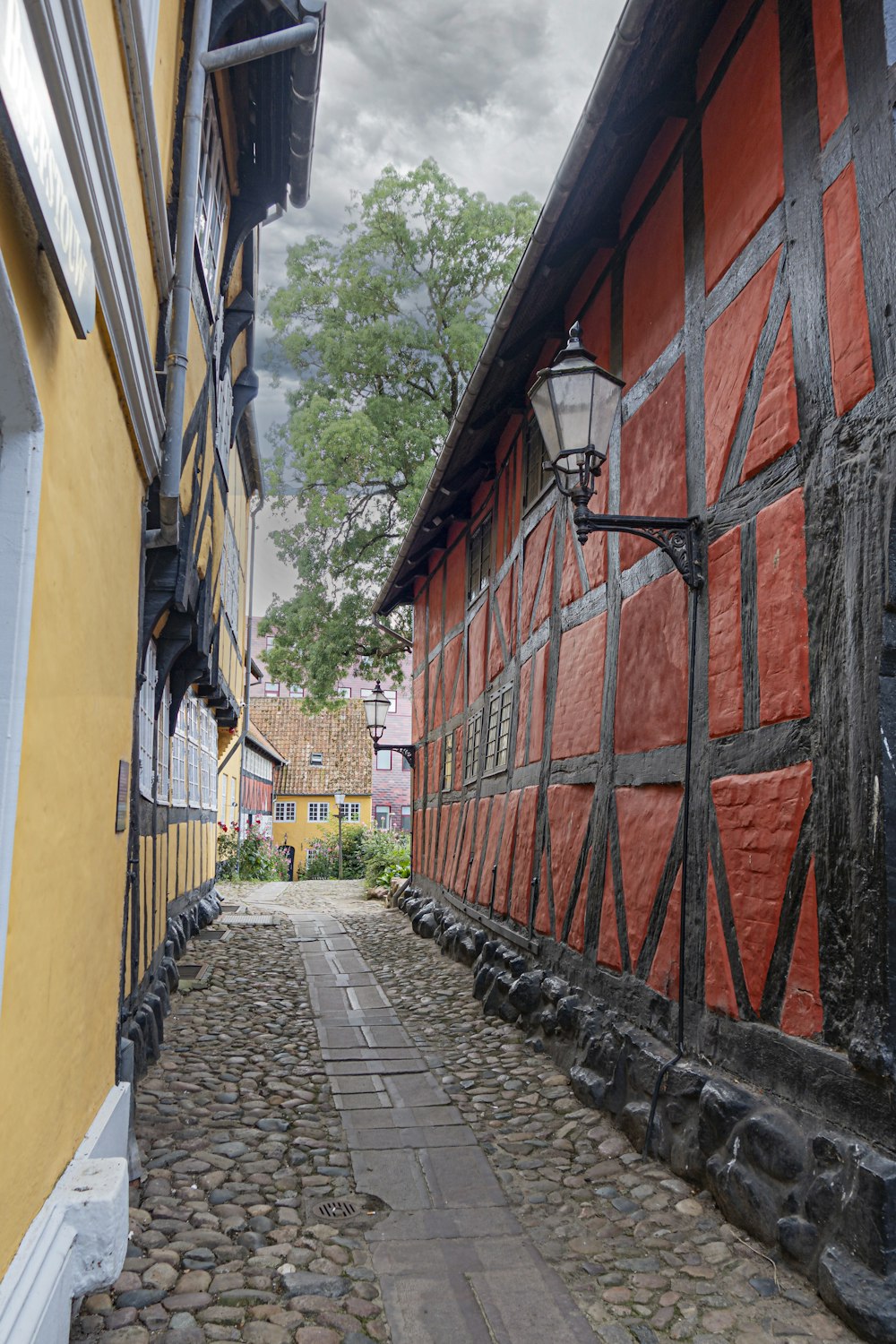 a cobblestone street lined with old buildings