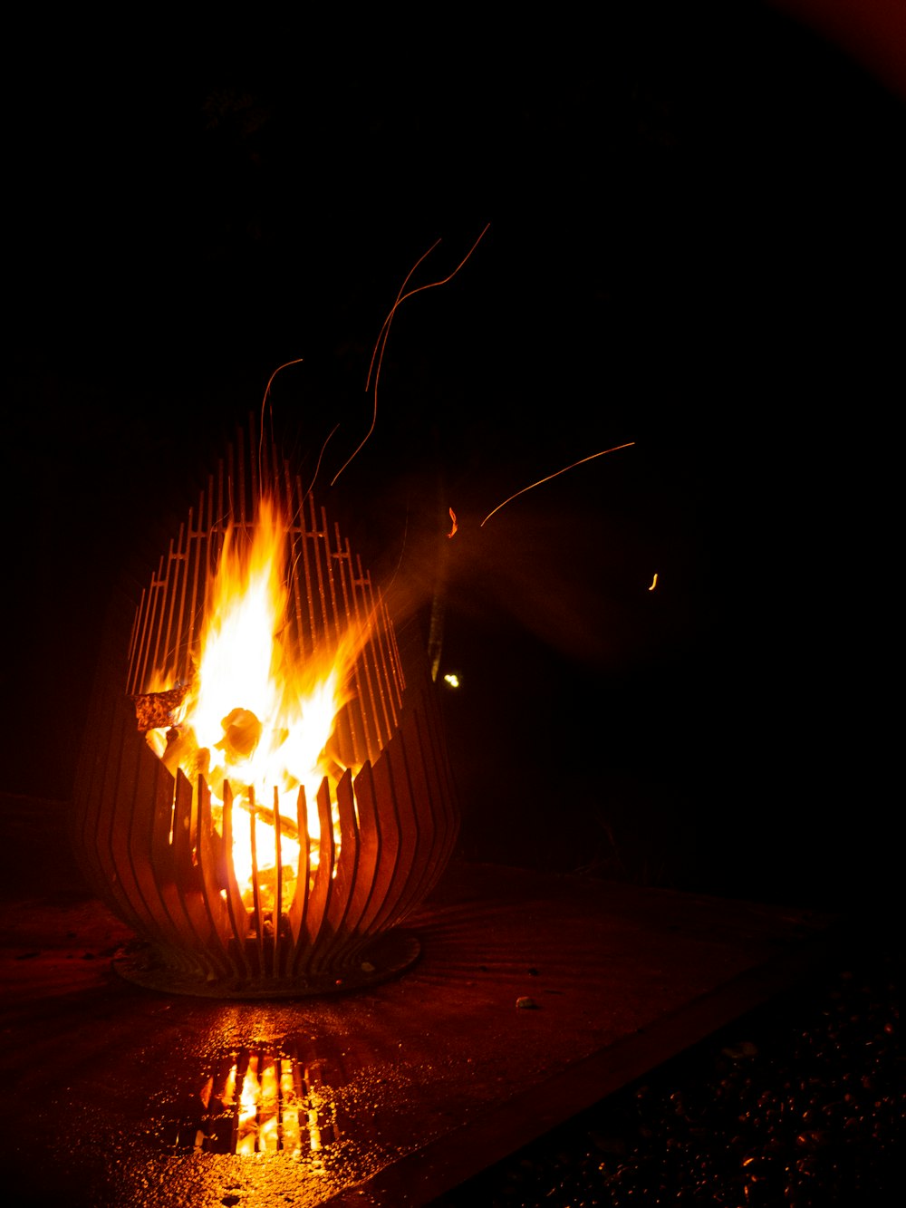 a fire pit is lit up in the dark