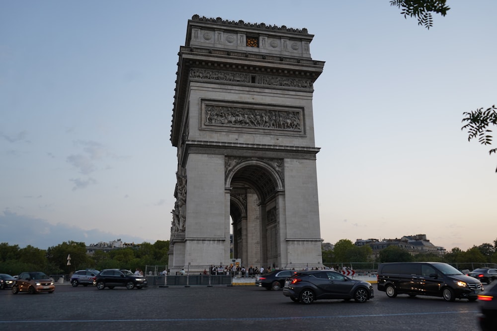 a group of cars parked in front of a monument