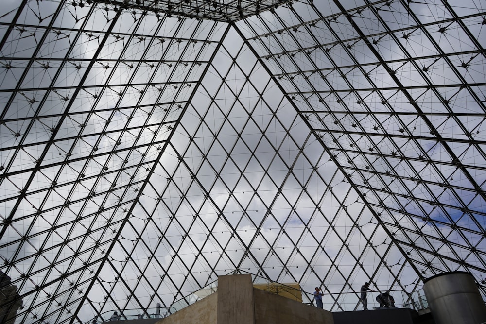 a very tall glass building with a sky background