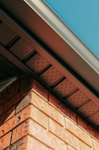 a close up of a brick building with a blue sky in the background