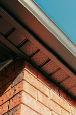 a close up of a brick building with a blue sky in the background