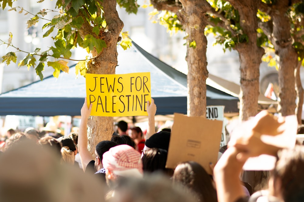 a crowd of people holding up yellow signs