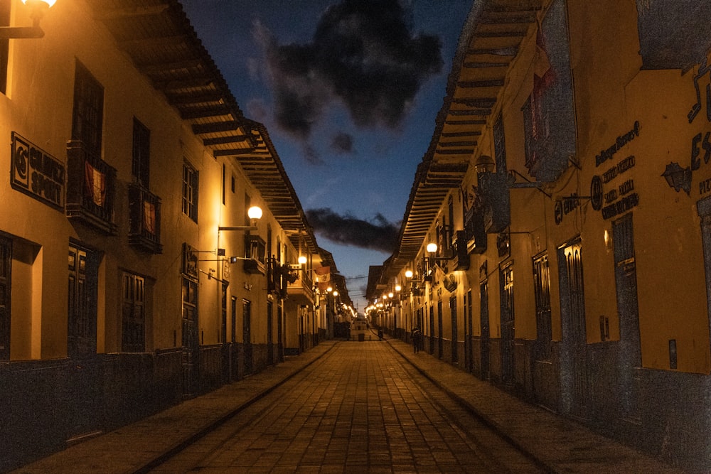 an empty street at night with lights on