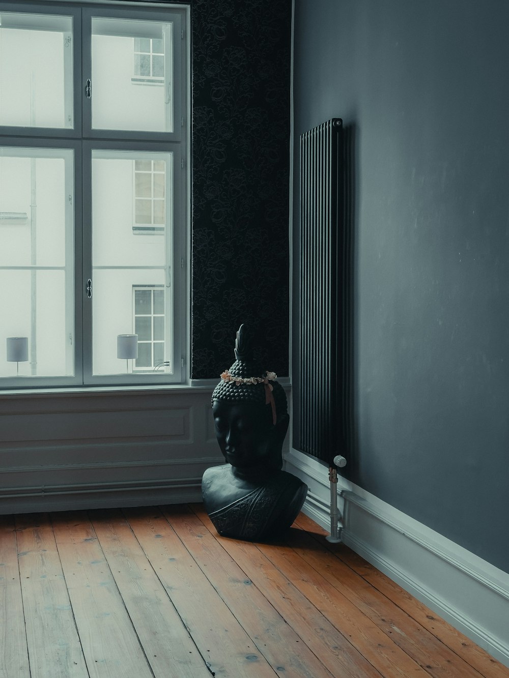 a black and white photo of a room with a radiator