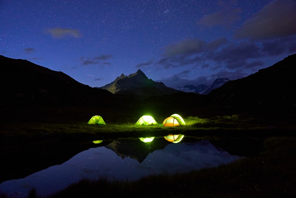 a couple of tents sitting on top of a lush green field