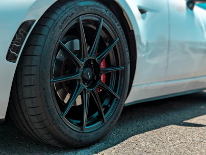 Close-up of a sleek sports car wheel with a high-performance tyre in motion.