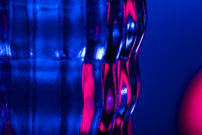 Close-up image of polished glass edges reflecting soft blue and gray tones.