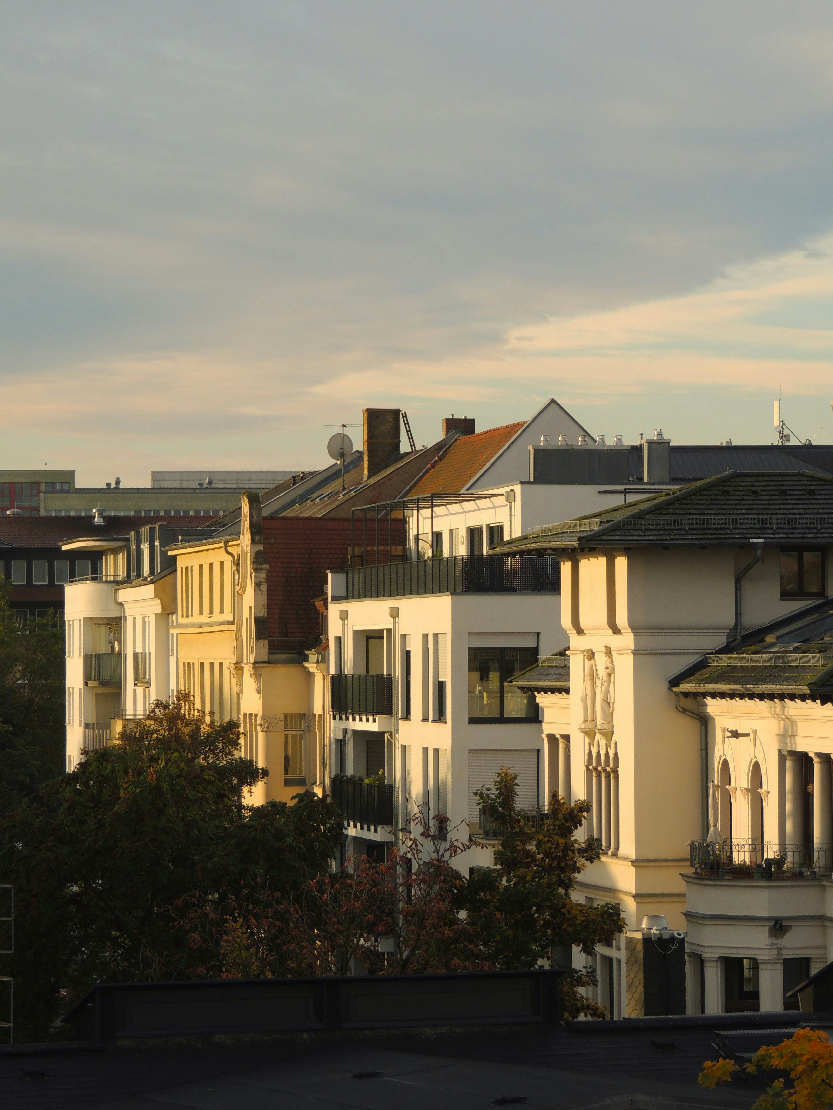 a row of houses with a cloudy sky in the background