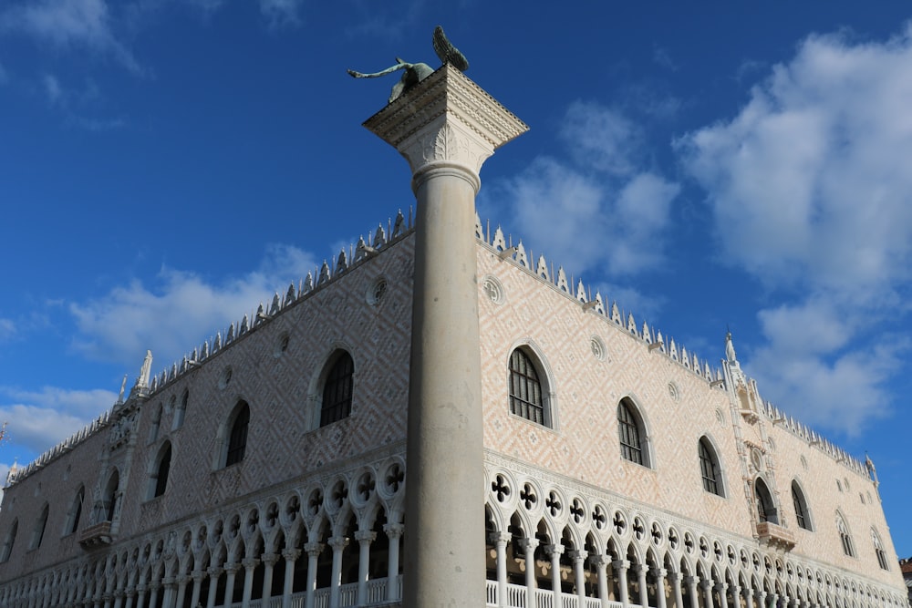 a tall building with a statue on top of it