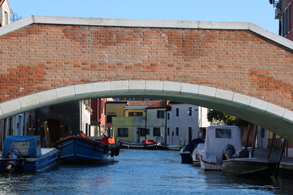 a bridge over a river with boats under it