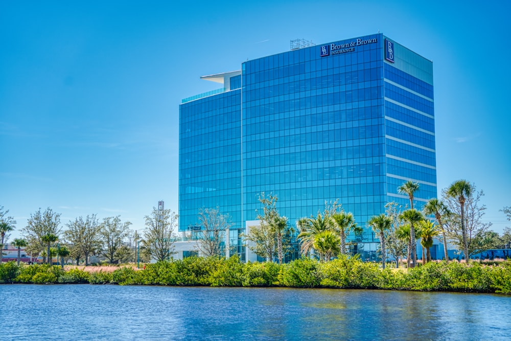 a large blue building next to a body of water