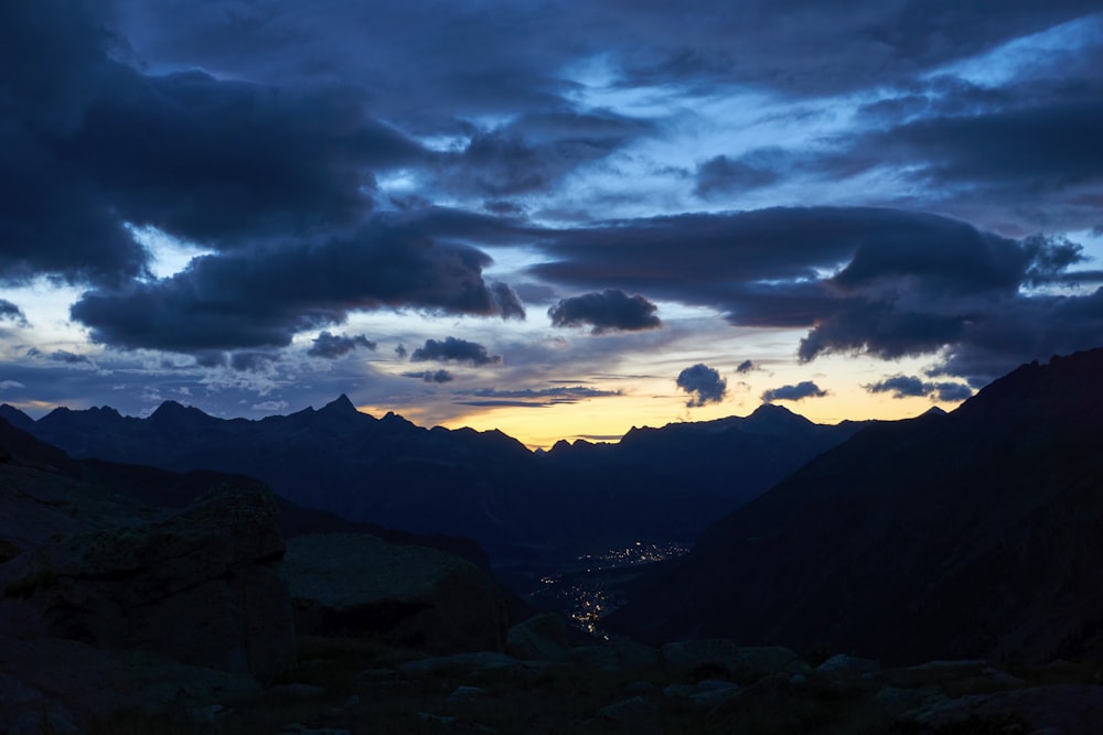 a view of a mountain range with a sunset in the background