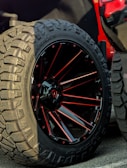 Close-up of a shiny custom rim mounted on a rugged off-road tire.