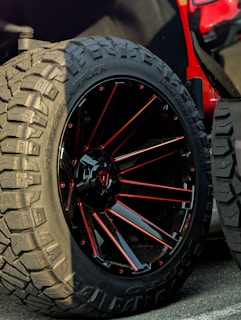 Close-up of a rugged off-road tire showcasing its aggressive tread pattern.