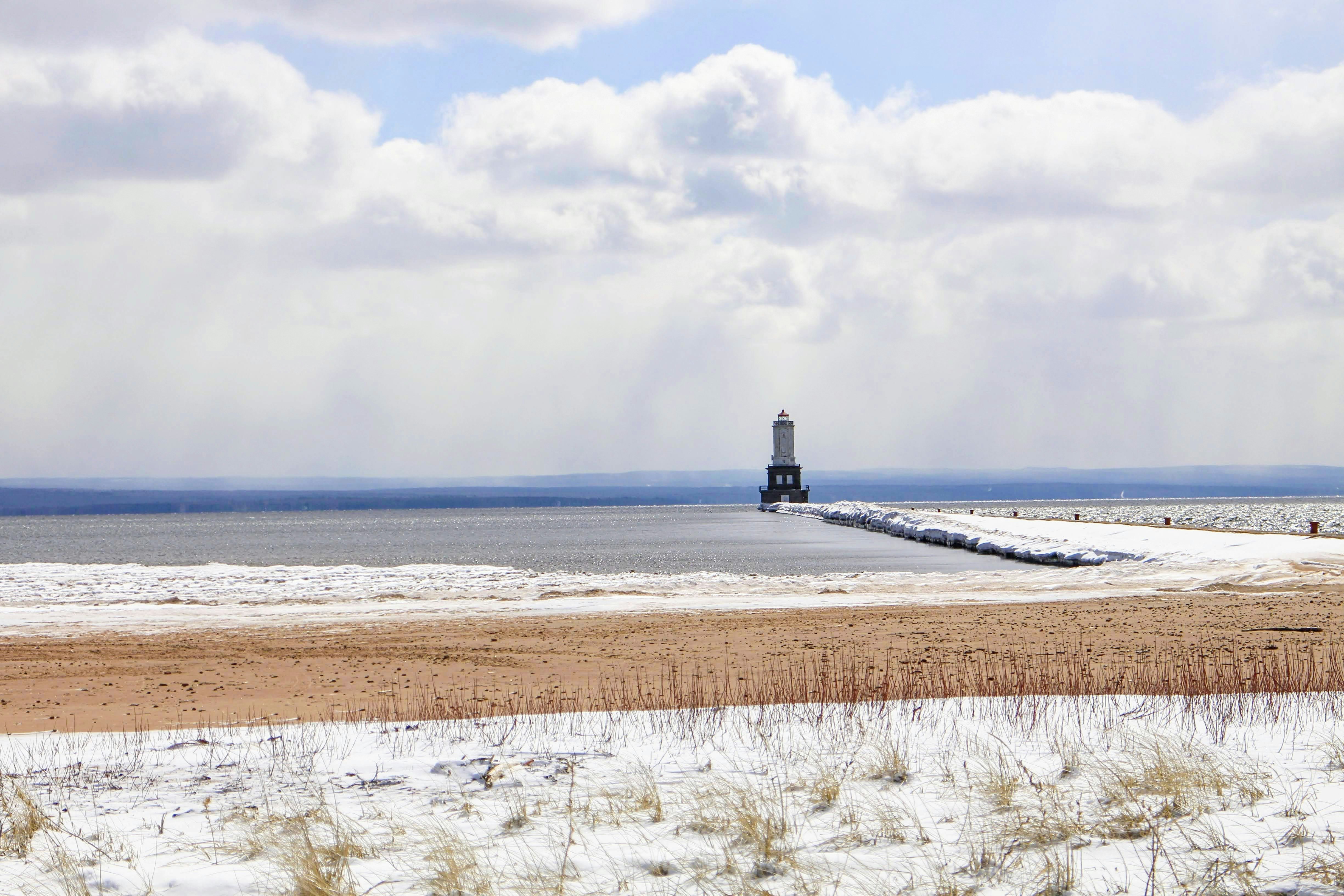 a large body of water sitting next to a sandy beach