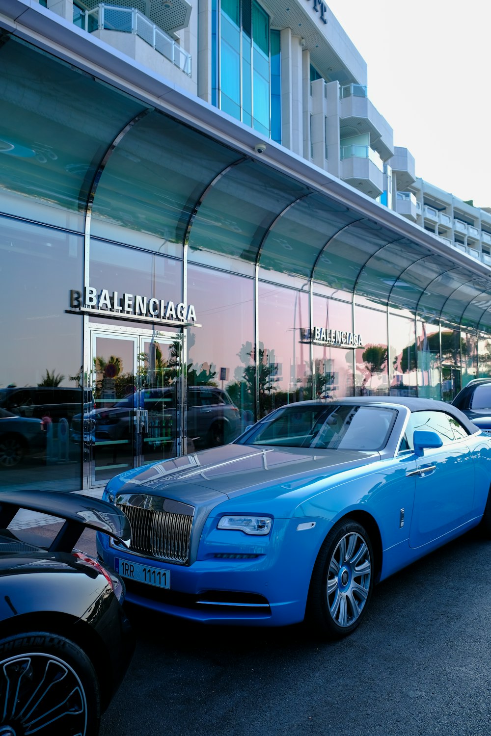 a row of parked cars in front of a building