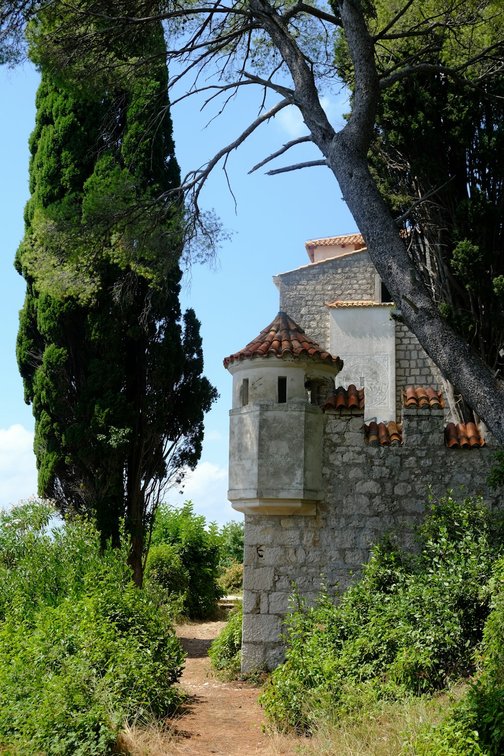 a stone building with a clock on the side of it