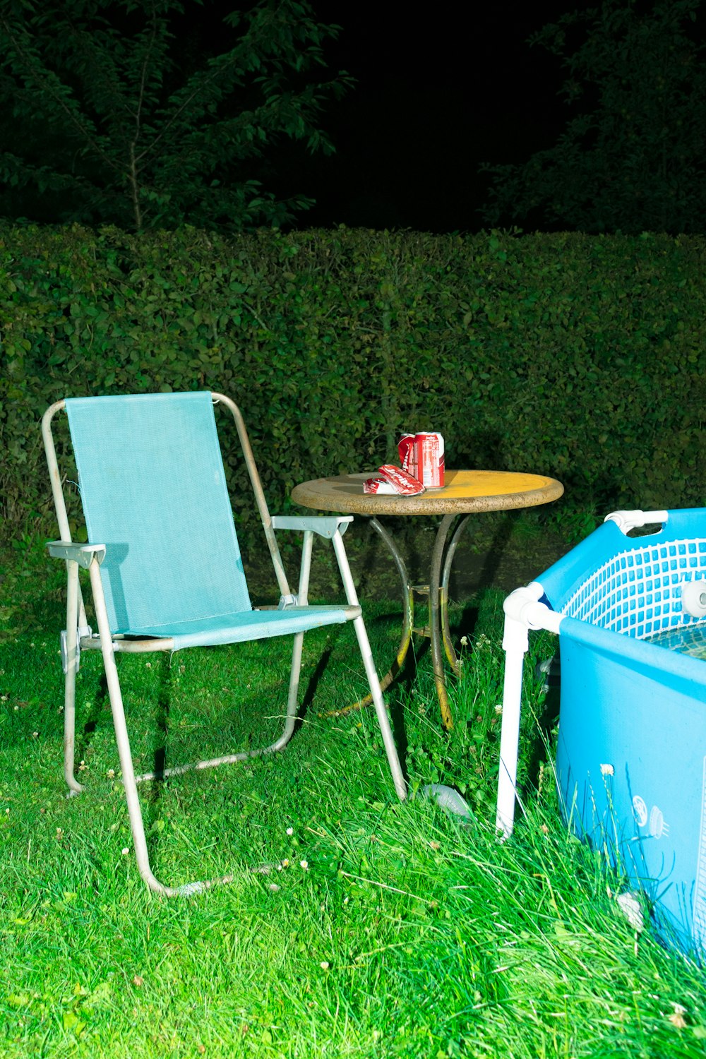 two chairs and a table in the grass