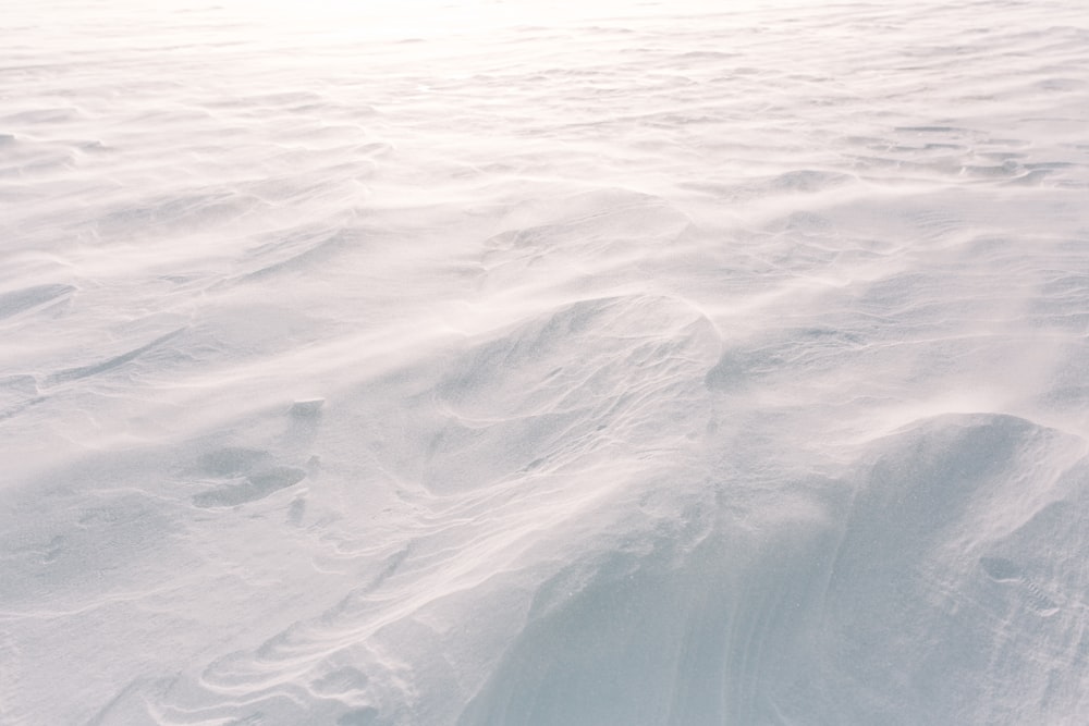 a person riding skis down a snow covered slope