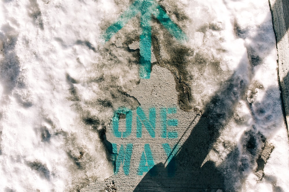 a sidewalk with a one way sign painted on it