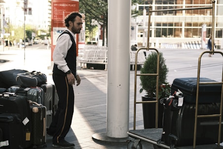 a man standing next to a pile of luggage