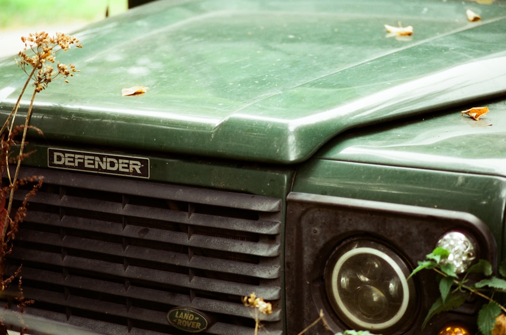a close up of the front of a green truck