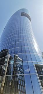Exterior view of Bihar Trade Tower showcasing its modern glass facade under a clear blue sky.