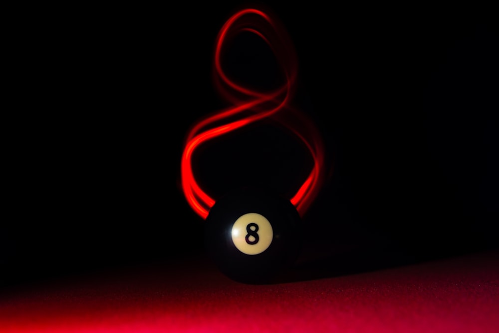 a billiard ball with a red light around it