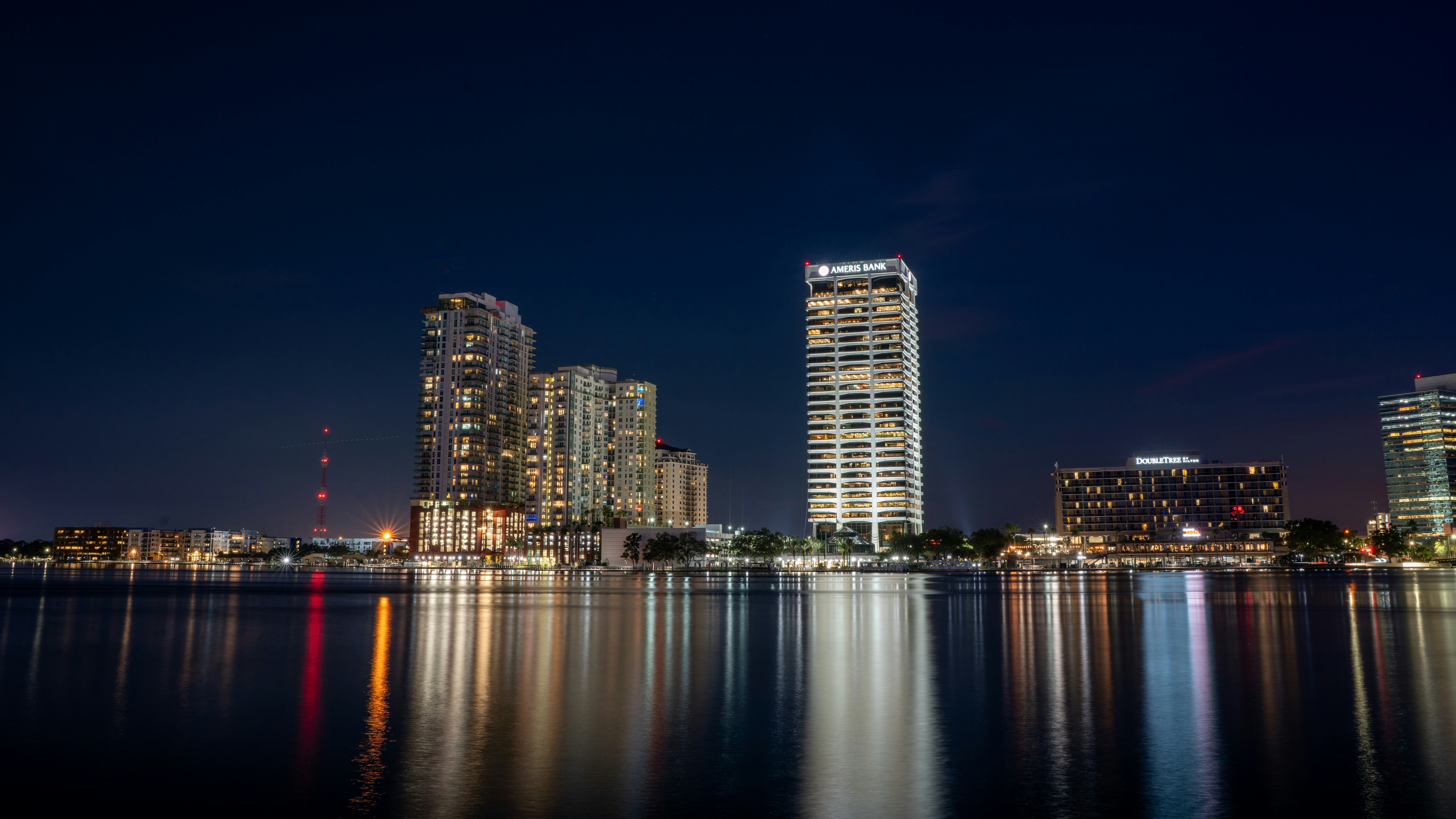 a view of a city at night from across the water, 