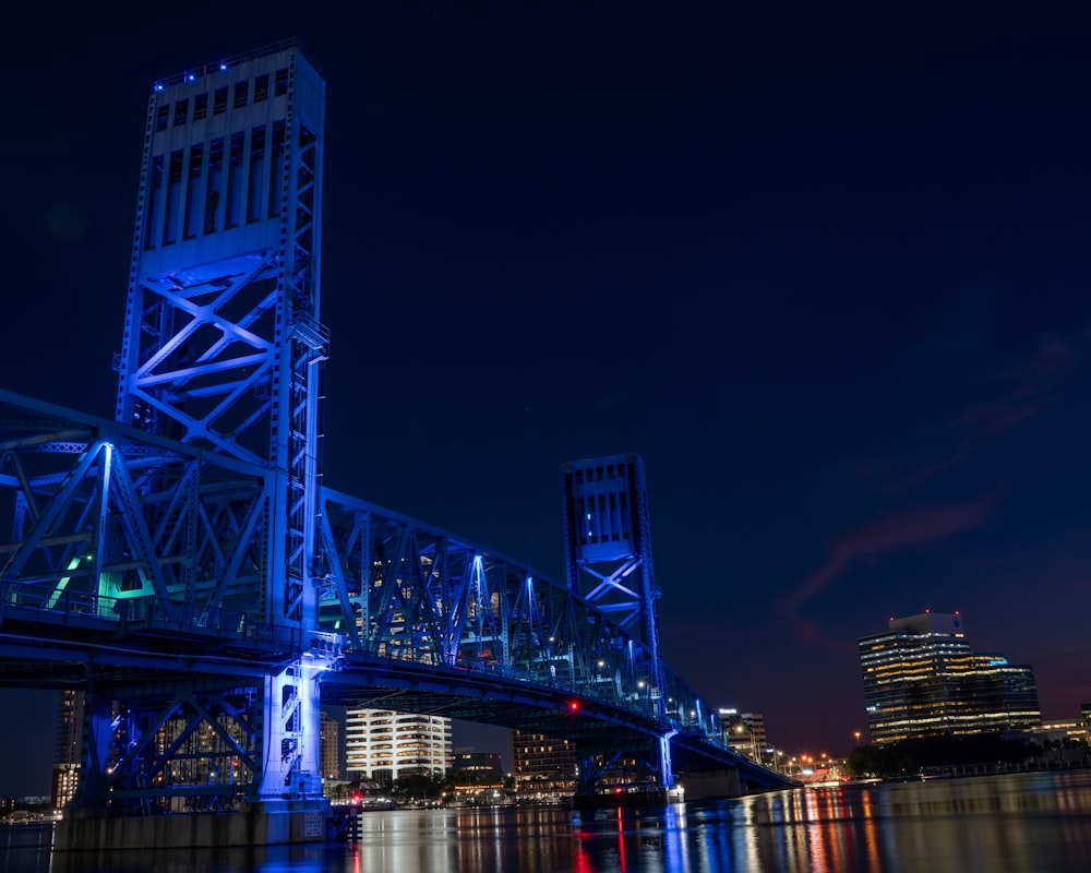 a bridge that is lit up with blue lights