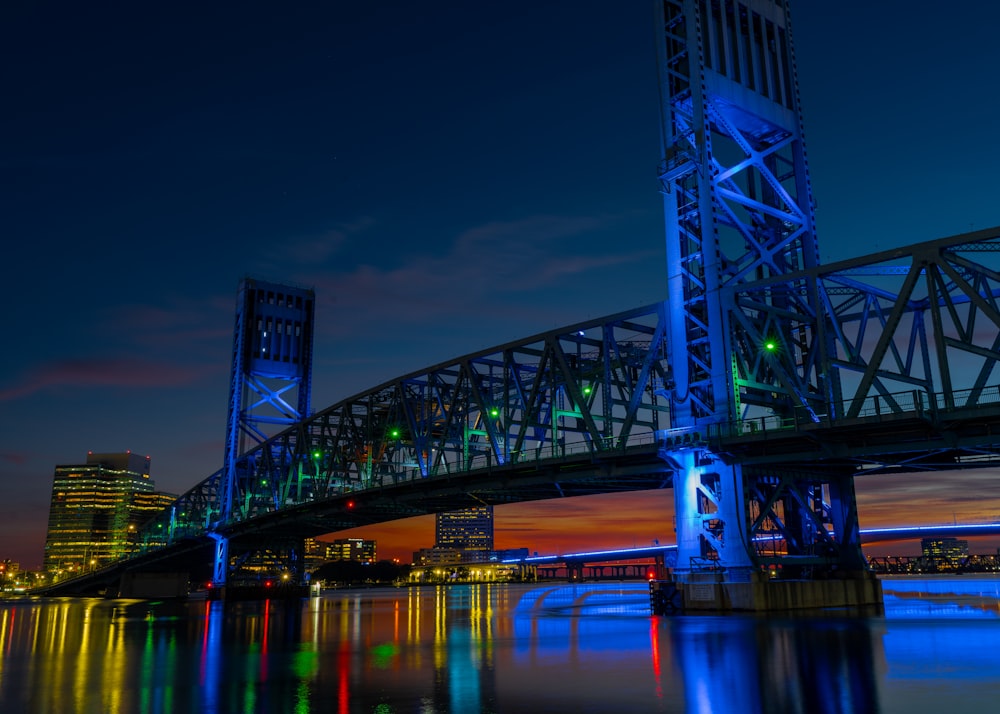 a large bridge over a body of water at night