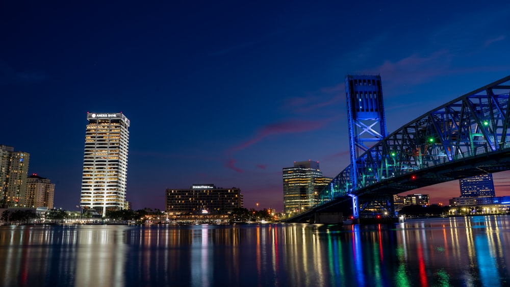 a bridge over a river with a city in the background