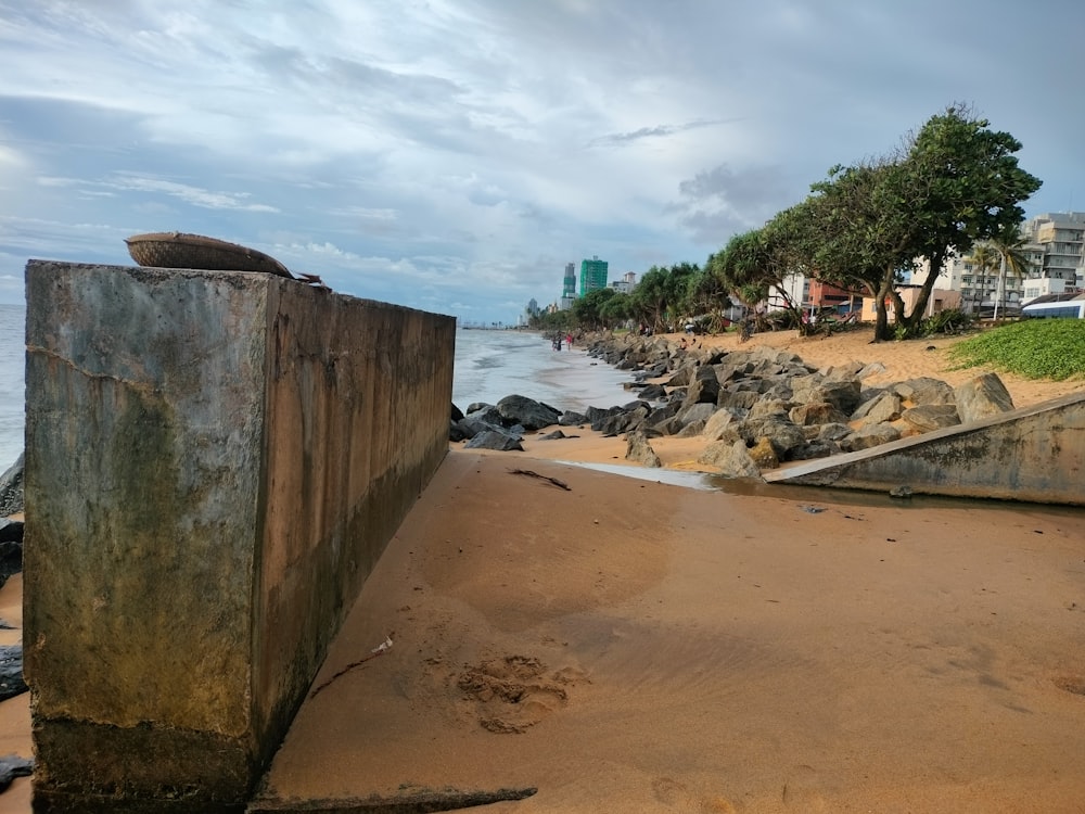 a large piece of wood sitting on top of a sandy beach