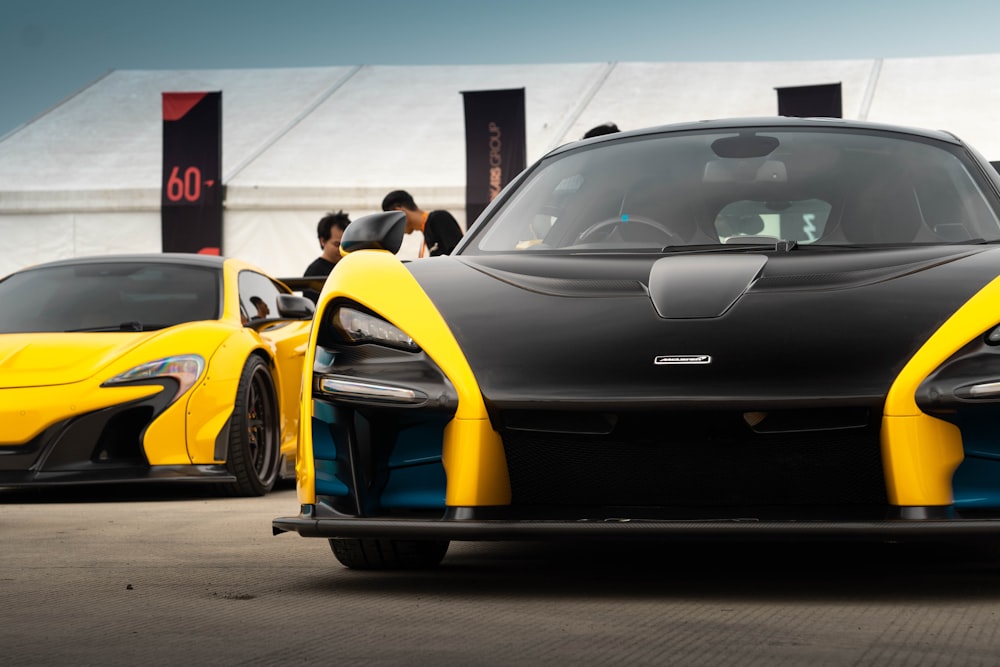 a black and yellow sports car parked in a parking lot