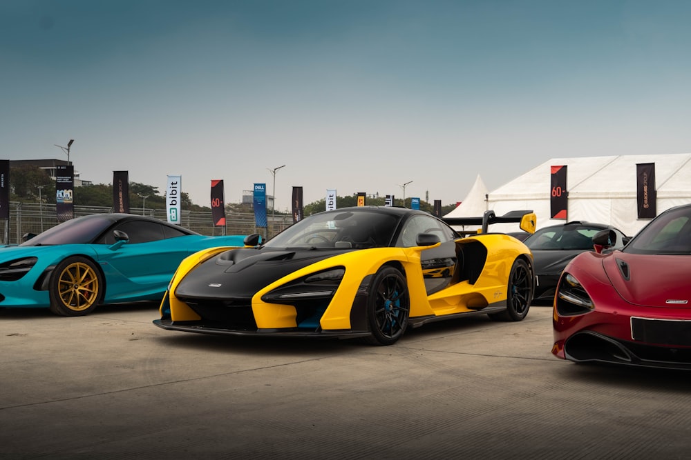 a group of three sports cars parked next to each other