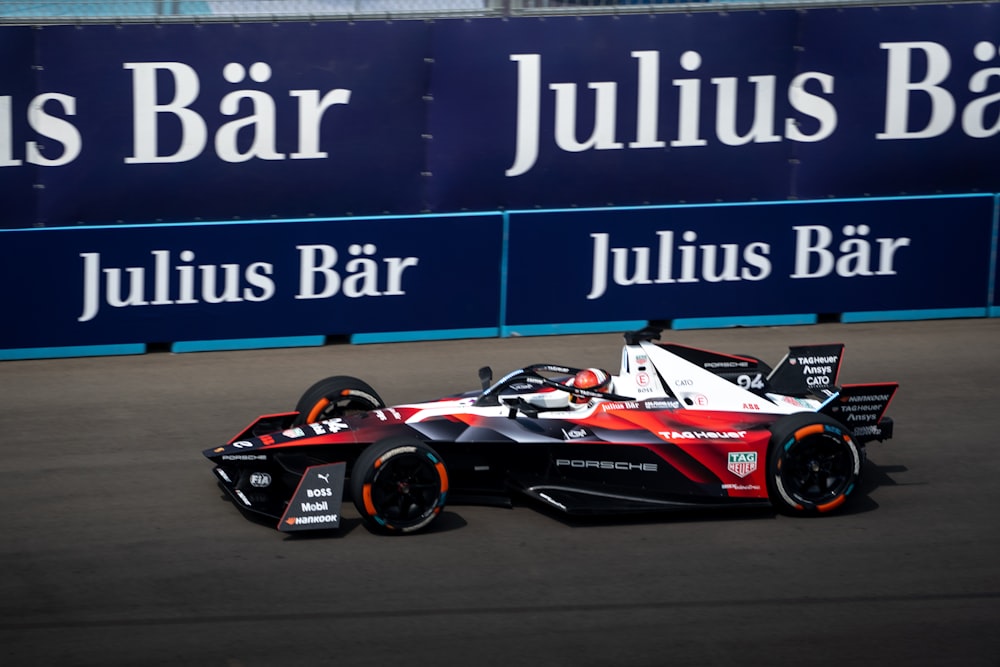 a man driving a race car on a track