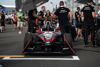 Corporate representatives shaking hands trackside with the Gualotuna Motorsports team.