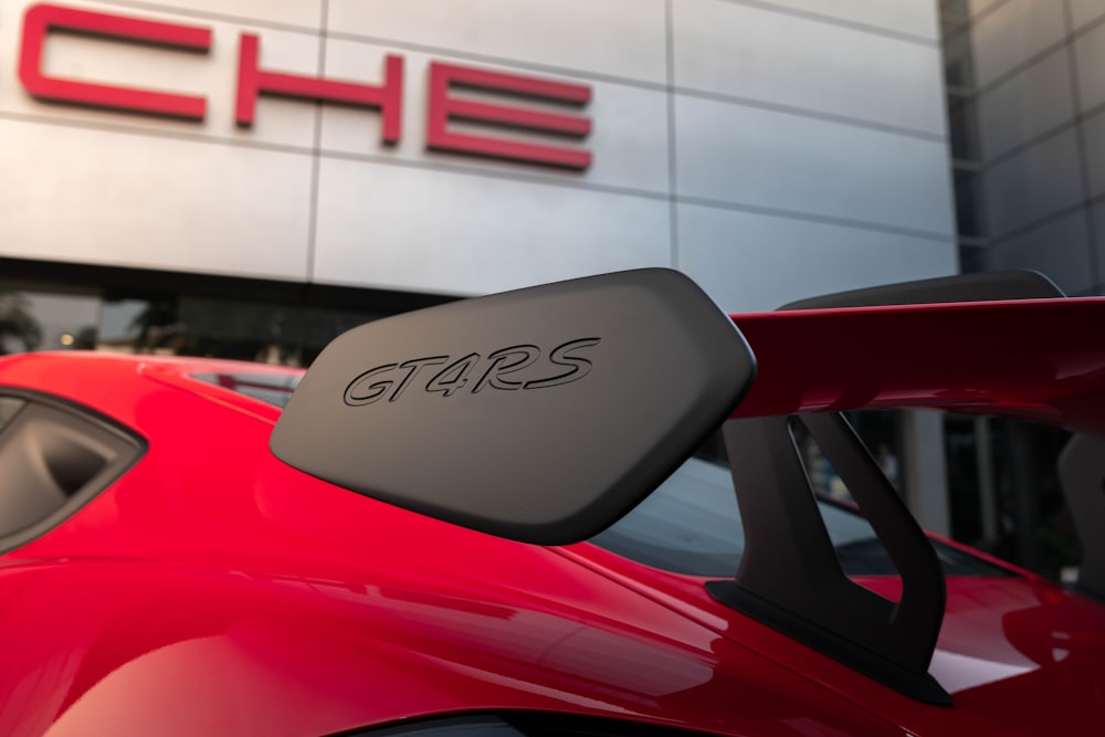 a red sports car parked in front of a building