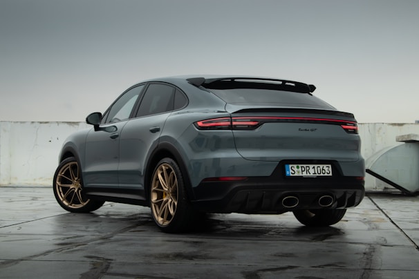 a grey porsche cayen is parked in a parking lot on premium tyres sold in Tyrepublic